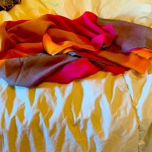 Lightweight polyester infinity scarf in orange, pink and gray ombre.